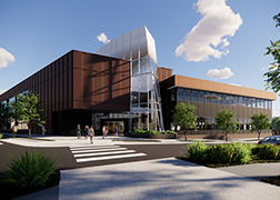 Rendering of a brick four-story building with a large white sculpture at the entrance.